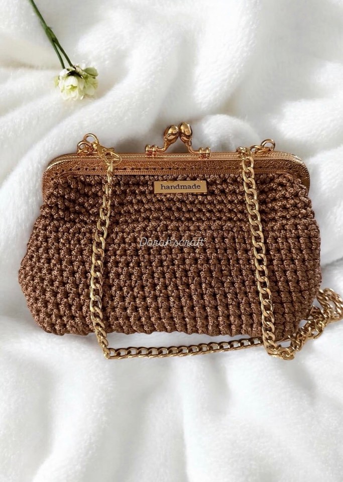 Engraved gold frame and chain on the bronze clutch